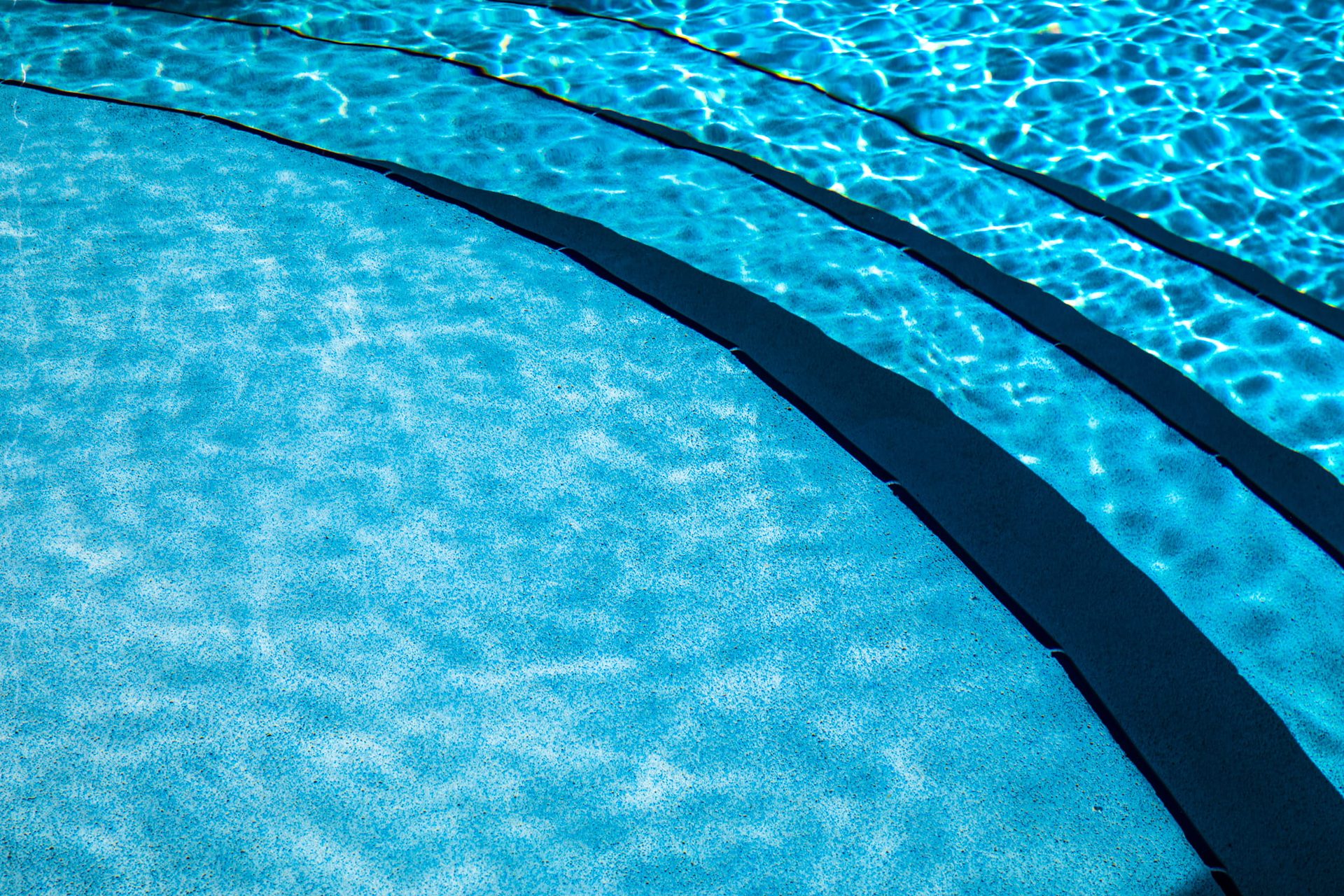 Sunlit swimming pool steps