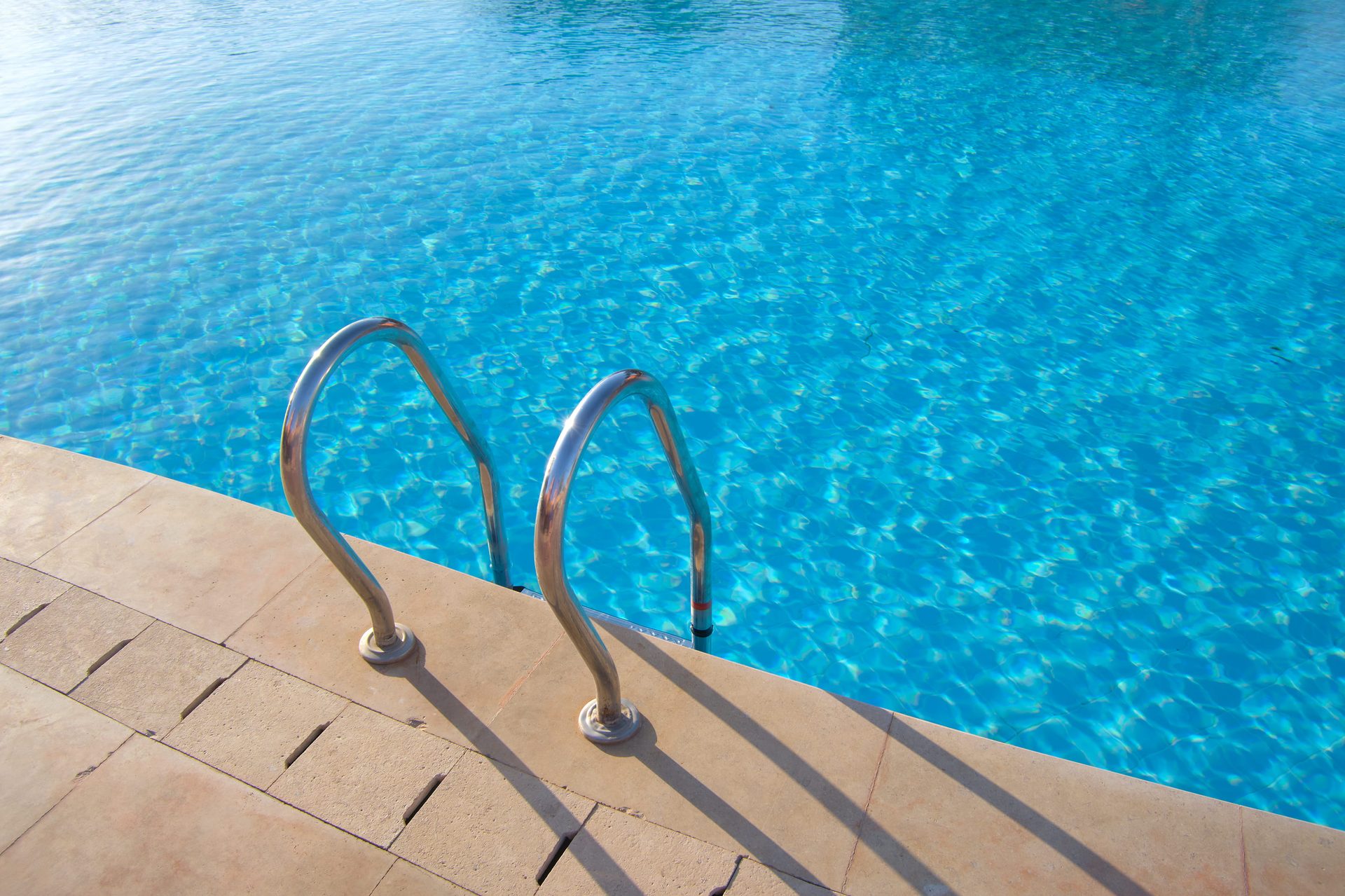 Polished stainless handrail and clean coping at a premium Sandton pool